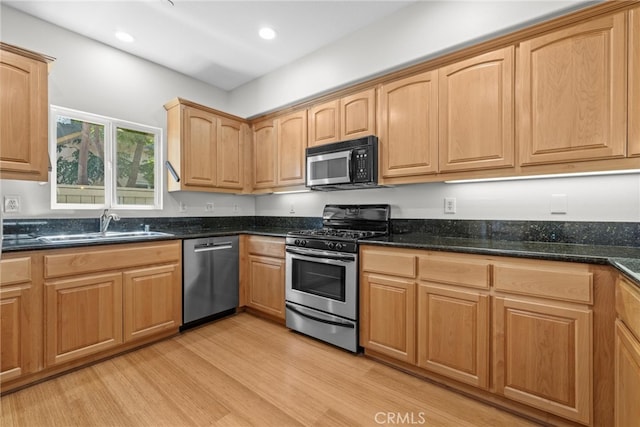 328 E Imperial Ave Unit 1, El Segundo, CA 90245 - kitchen featuring stainless steel appliances, light wood finished floors, a sink, dark stone counters, and recessed lighting