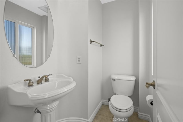 bathroom with toilet and tile patterned flooring