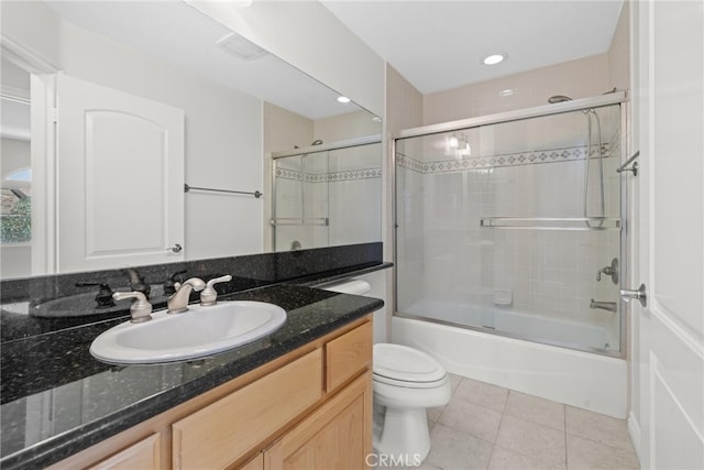 full bathroom with toilet, tile patterned flooring, shower / bath combination with glass door, and vanity