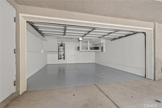 garage with gas water heater and a garage door opener