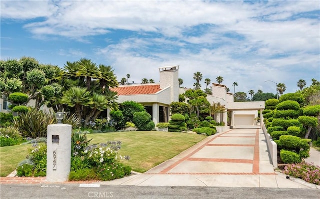 mediterranean / spanish home featuring a front yard