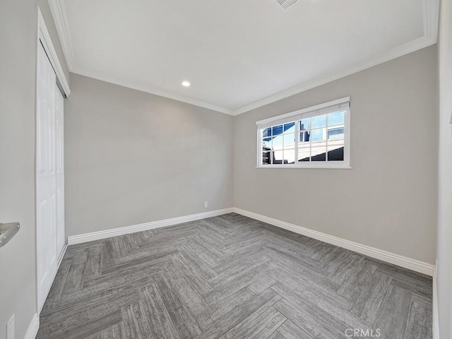 unfurnished room featuring ornamental molding and baseboards