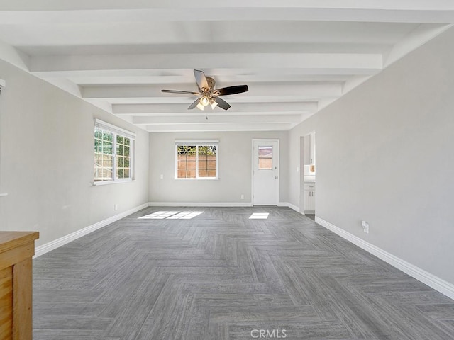 unfurnished living room featuring a ceiling fan, baseboards, and beam ceiling