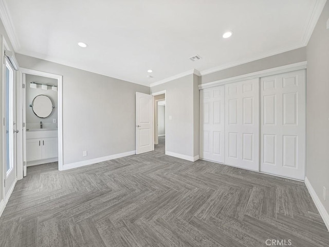 unfurnished bedroom with crown molding, baseboards, a sink, and recessed lighting