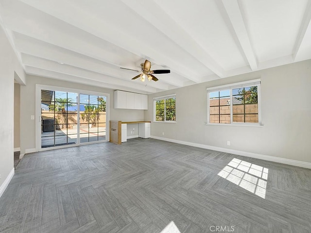 unfurnished living room featuring ceiling fan, built in study area, beam ceiling, and baseboards