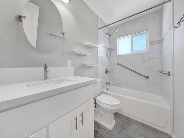 bathroom with shower / bathtub combination, toilet, and vanity