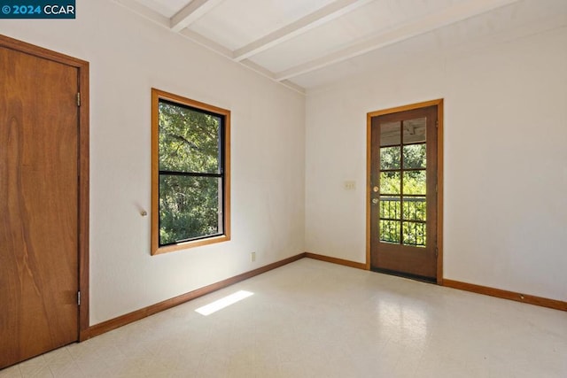 unfurnished room with beam ceiling and a healthy amount of sunlight