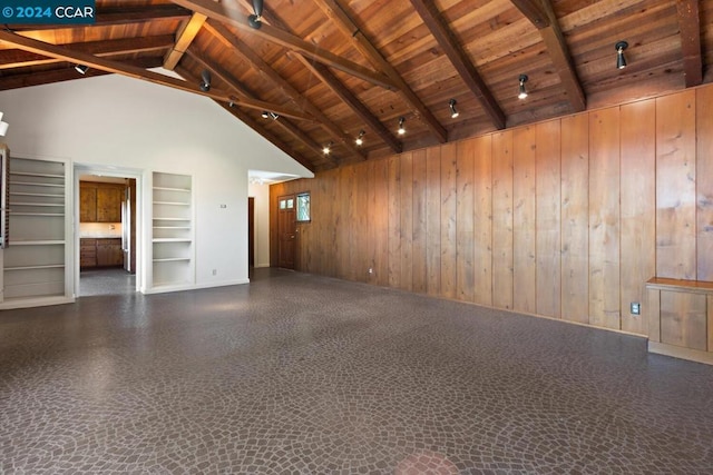 unfurnished living room with wood ceiling, built in shelves, wooden walls, beam ceiling, and high vaulted ceiling