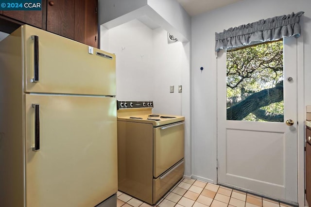 kitchen with light tile patterned floors and white appliances