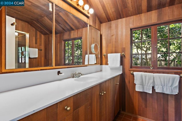 bathroom with a wealth of natural light, wooden walls, wooden ceiling, and lofted ceiling