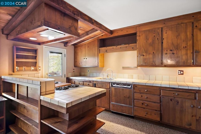 kitchen with gas stovetop, tile counters, paneled dishwasher, and custom exhaust hood