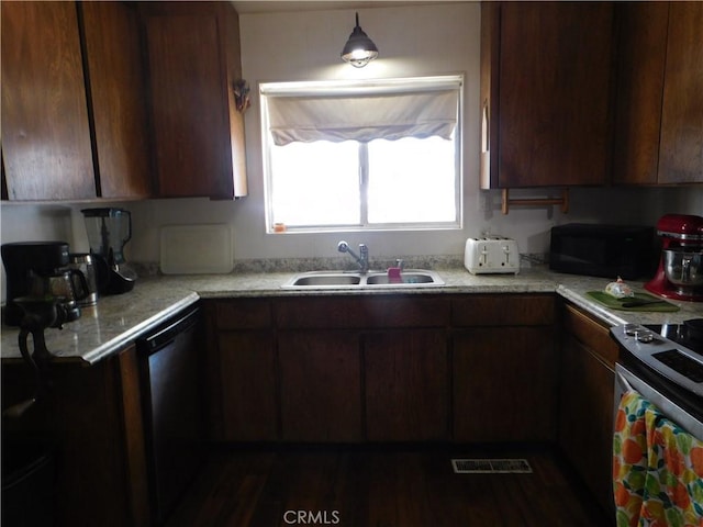 kitchen with dark wood-type flooring, black appliances, and sink