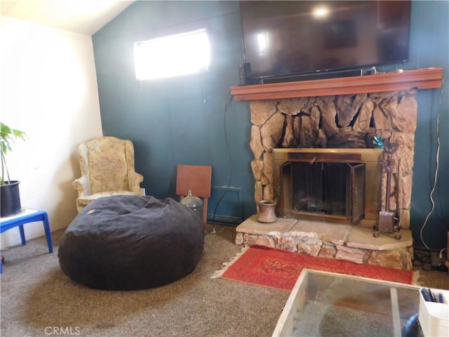 living area with carpet flooring, a fireplace, and vaulted ceiling