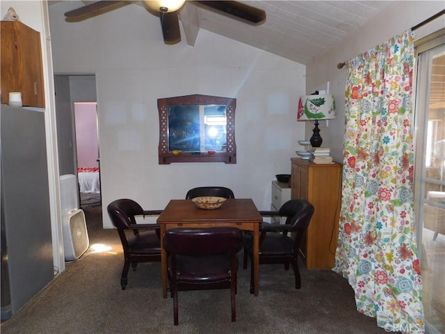 carpeted dining space featuring vaulted ceiling with beams and ceiling fan