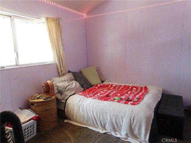 bedroom featuring carpet flooring and vaulted ceiling