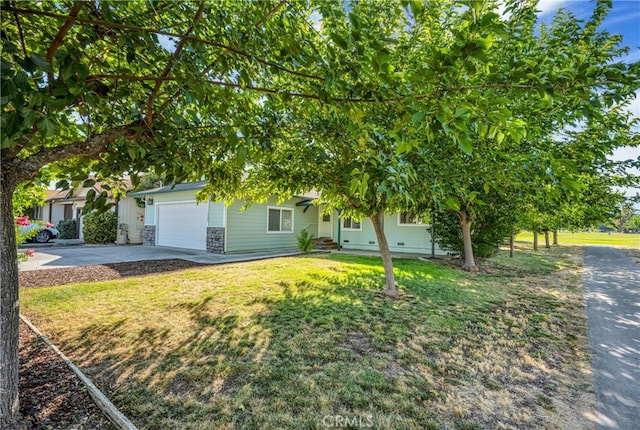 obstructed view of property with a front yard and a garage