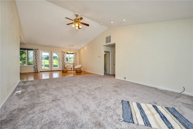 unfurnished living room featuring ceiling fan, french doors, carpet, and high vaulted ceiling