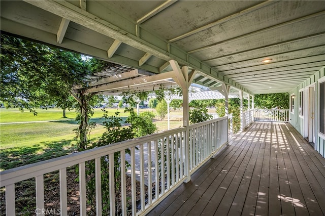 wooden terrace with a pergola and a yard