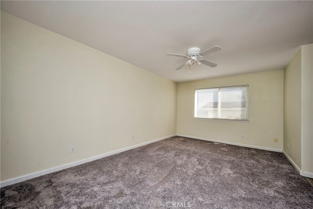 carpeted spare room with ceiling fan and a textured ceiling