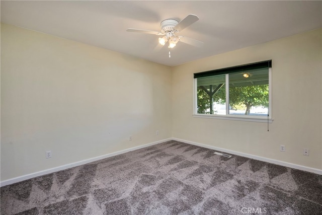 spare room with carpet floors and ceiling fan