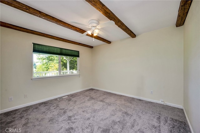 unfurnished room with carpet, beam ceiling, and ceiling fan