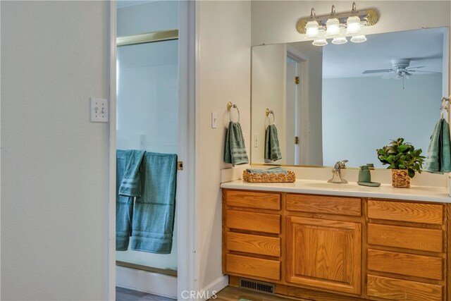 bathroom featuring ceiling fan and vanity