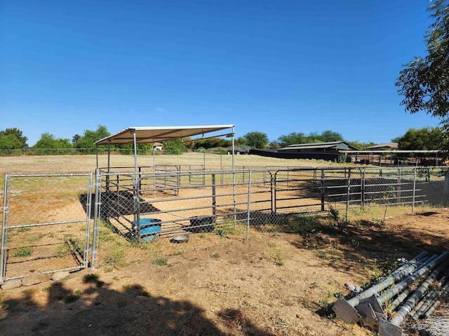 view of yard with a rural view and an outdoor structure