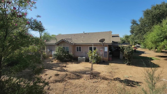 back of house featuring central AC