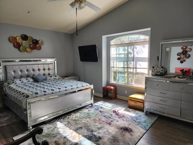 bedroom with dark hardwood / wood-style flooring, vaulted ceiling, and ceiling fan