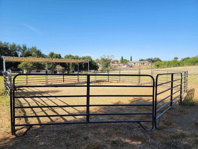 view of gate with a rural view