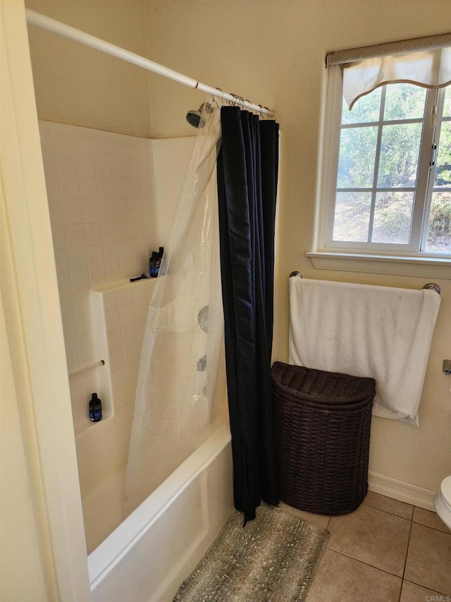 bathroom with tile patterned flooring, shower / tub combo with curtain, and toilet