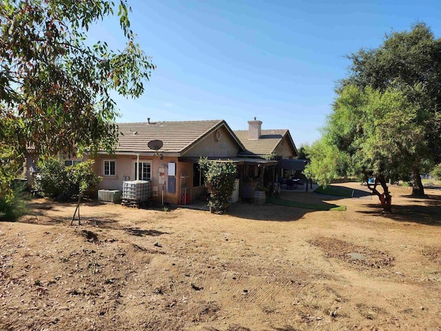 back of house featuring cooling unit