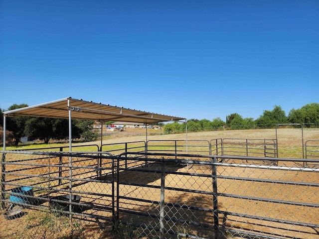 view of stable with a rural view