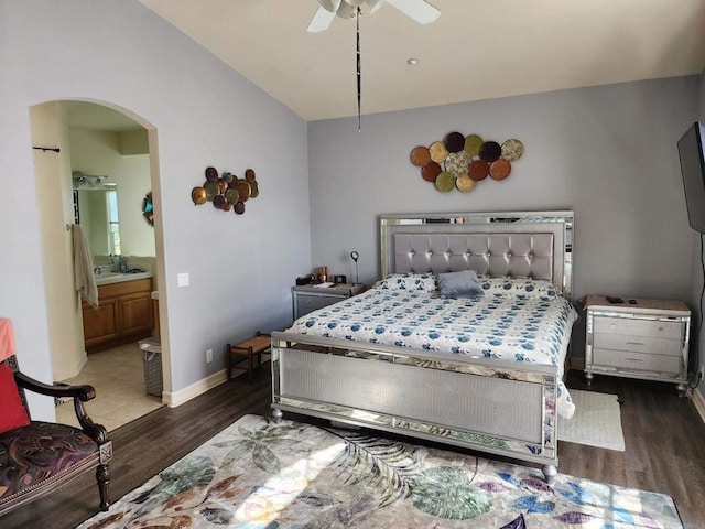 bedroom featuring ensuite bath, ceiling fan, sink, and dark hardwood / wood-style floors