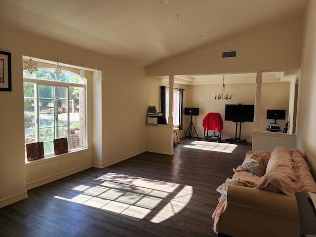 living room featuring lofted ceiling, dark wood-type flooring, and an inviting chandelier