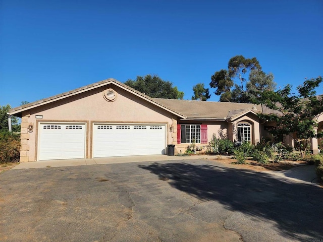 ranch-style home featuring a garage