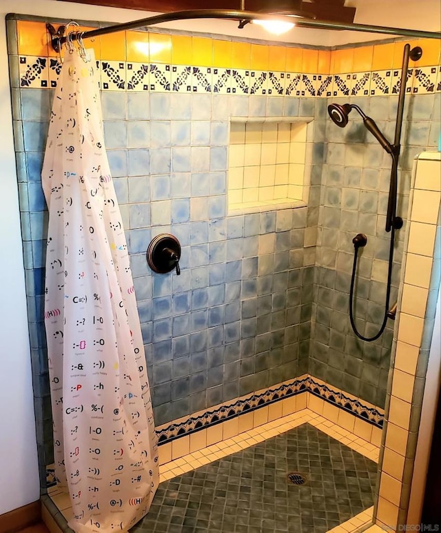 bathroom featuring tile patterned floors and a shower with shower curtain