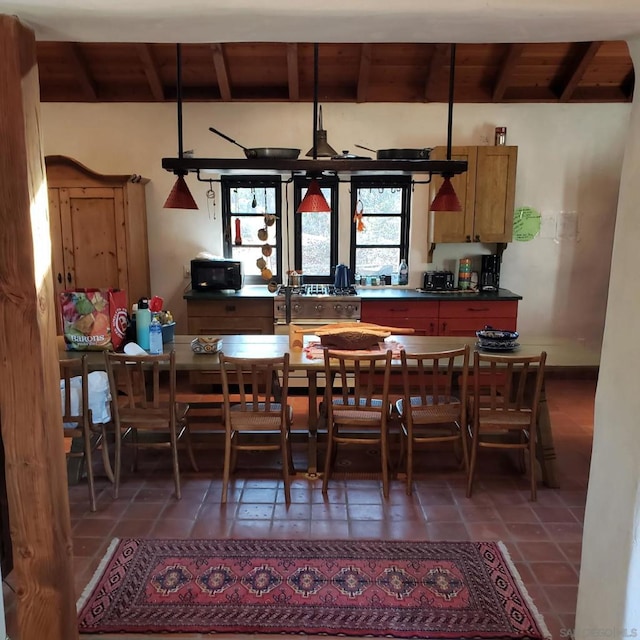 tiled dining room with wooden ceiling and vaulted ceiling with beams