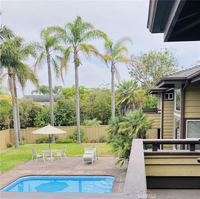 view of swimming pool with a lawn and a patio area