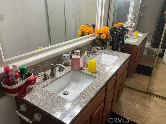 bathroom with vanity, toilet, and an enclosed shower