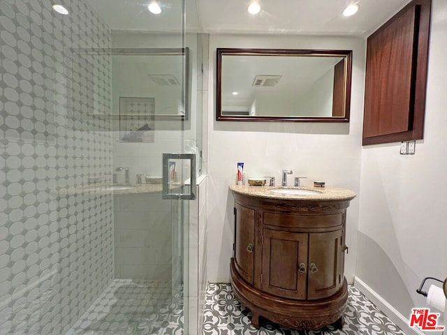 bathroom featuring vanity, tile patterned flooring, and walk in shower