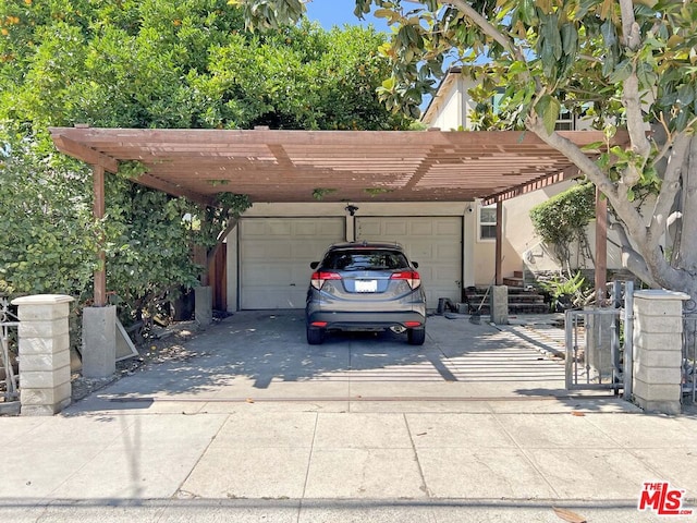 view of parking / parking lot with a carport and a garage