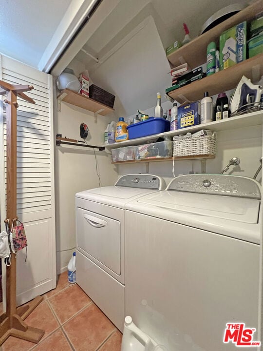 washroom featuring washer and dryer and light tile patterned floors