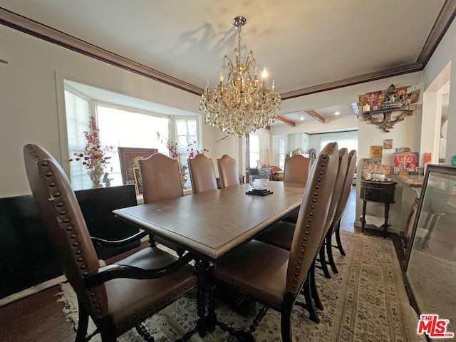 dining space featuring crown molding and a chandelier