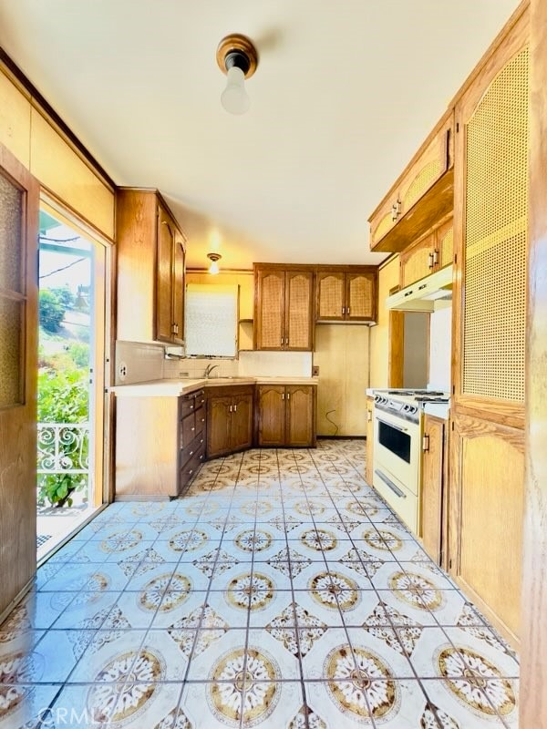 kitchen featuring sink and white stove