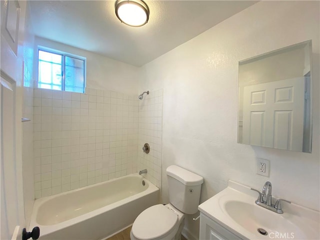 full bathroom with vanity, toilet, and tiled shower / bath