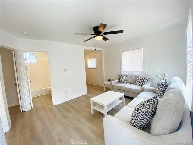 living room featuring ceiling fan, a healthy amount of sunlight, and light hardwood / wood-style floors