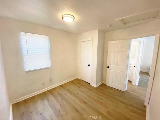 unfurnished bedroom with hardwood / wood-style floors and a closet