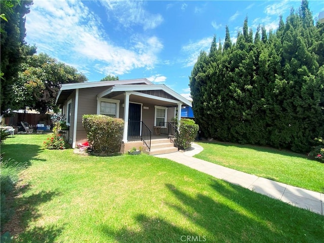 bungalow-style home with a front lawn and covered porch