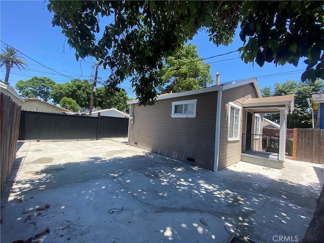 view of property exterior with a patio area